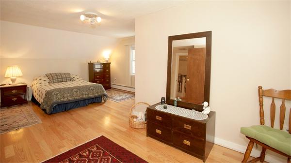273 Conant Road Weston, MA 02493 - Photo 9 of 12 a bedroom with a bed and a mirror on dresser