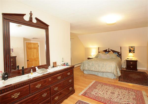 273 Conant Road Weston, MA 02493 - Photo 10 of 12 a bedroom with a bed and wooden floor