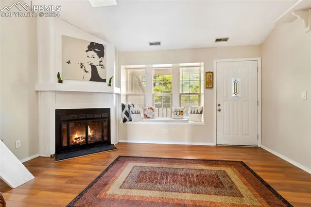 a view of a living room with a fireplace