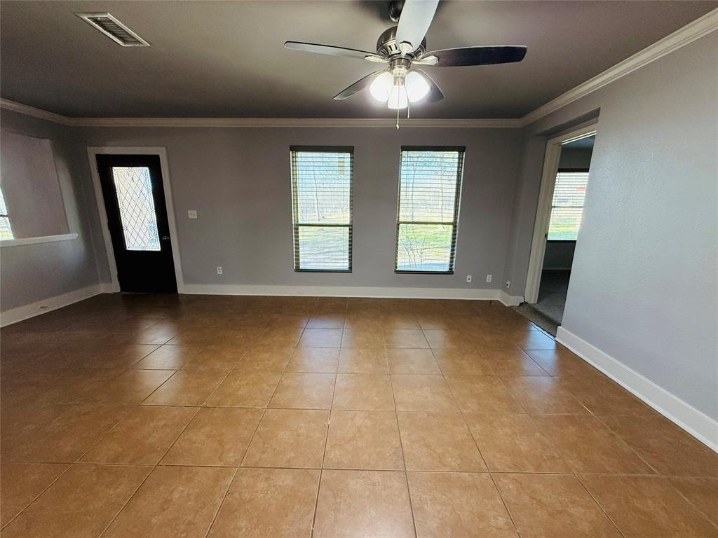 529 Northwest Private Road 147 Rice, TX 75155 - Photo 12 of 20 Unfurnished room featuring ornamental molding, light tile patterned floors, and plenty of natural light