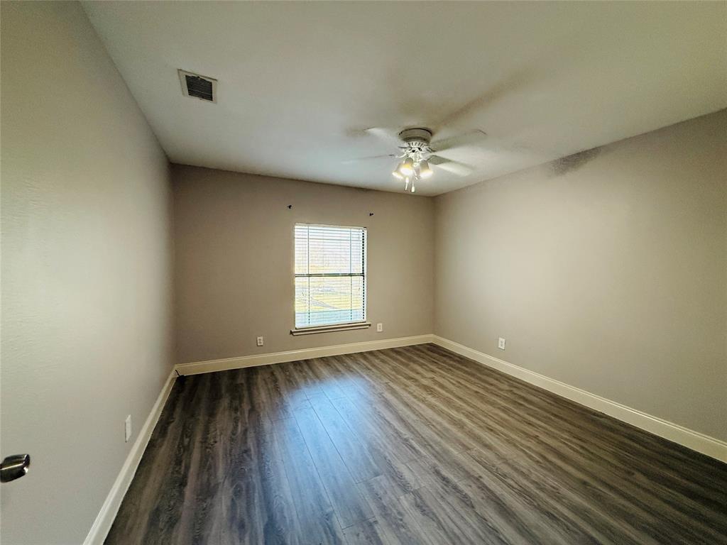 529 Northwest Private Road 147 Rice, TX 75155 - Photo 14 of 20 Unfurnished room featuring dark wood-style flooring and ceiling fan