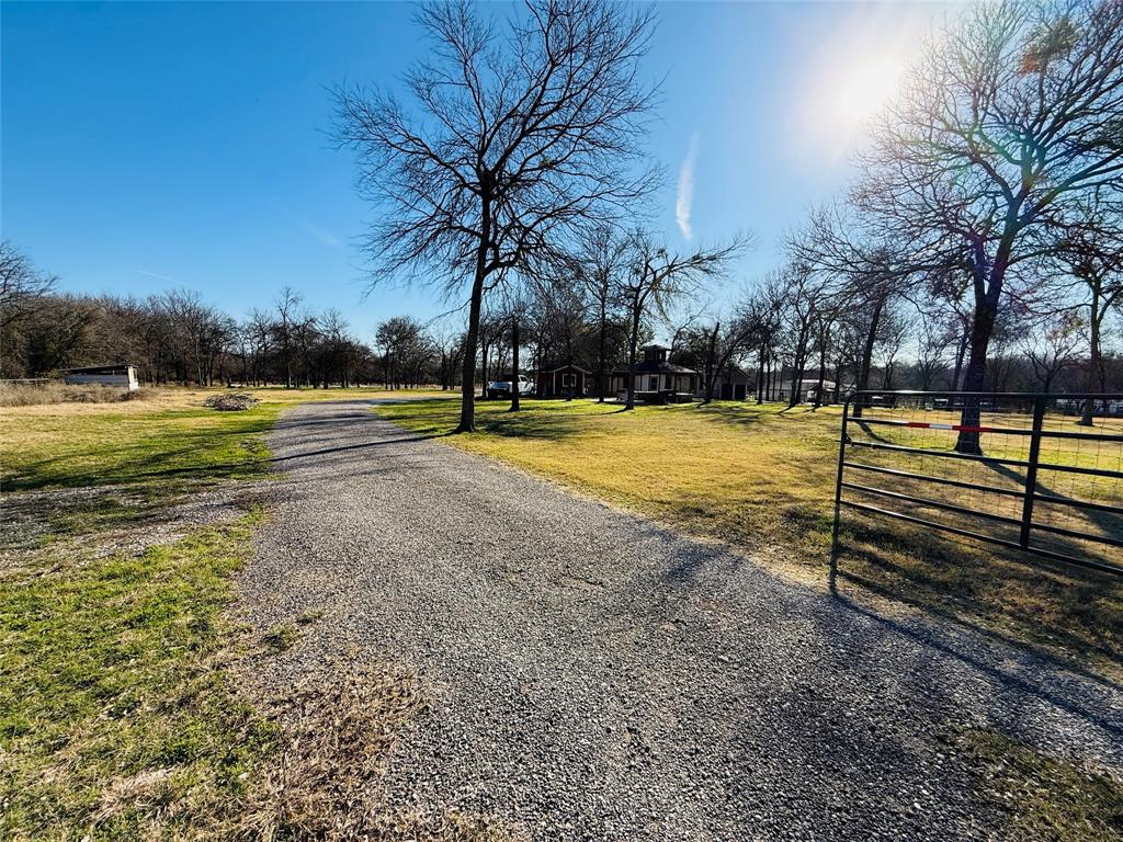 529 Northwest Private Road 147 Rice, TX 75155 - Photo 19 of 20 View of dirt / gravel road with a gated entry