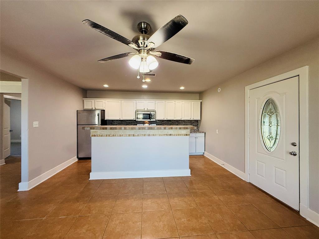 529 Northwest Private Road 147 Rice, TX 75155 - Photo 7 of 20 Kitchen with ceiling fan, stainless steel appliances, white cabinetry, recessed lighting, and dark tile patterned flooring