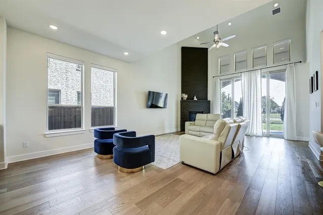 a living room with furniture windows and wooden floor