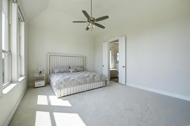 a bedroom with a bed and a ceiling fan