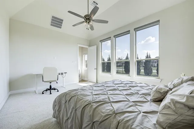 a bedroom with a bed and glass walk in closet