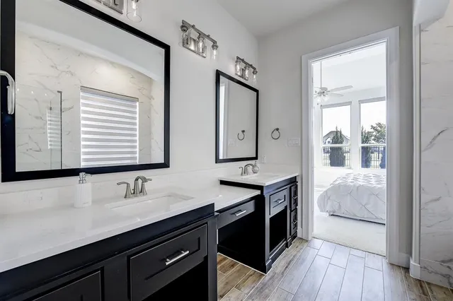 a en suite bathroom with a sink double vanity and a mirror