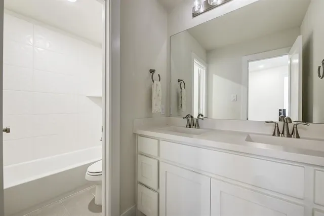a bathroom with a double vanity sink and a mirror