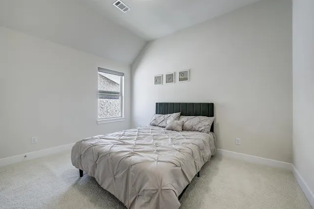 a bedroom with a bed and window