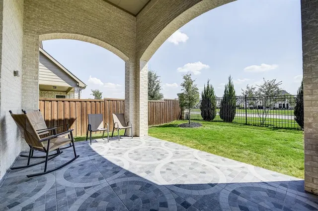 a backyard of a house with table and chairs