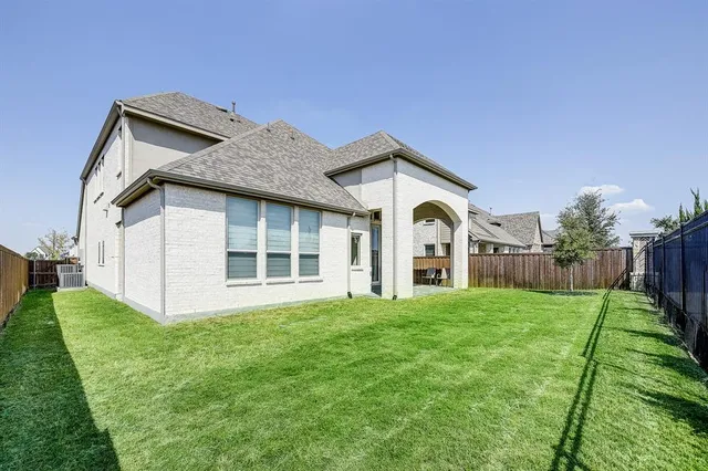 a big house with a big yard and more large trees