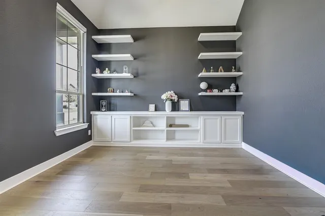 a view of kitchen with cabinets and window