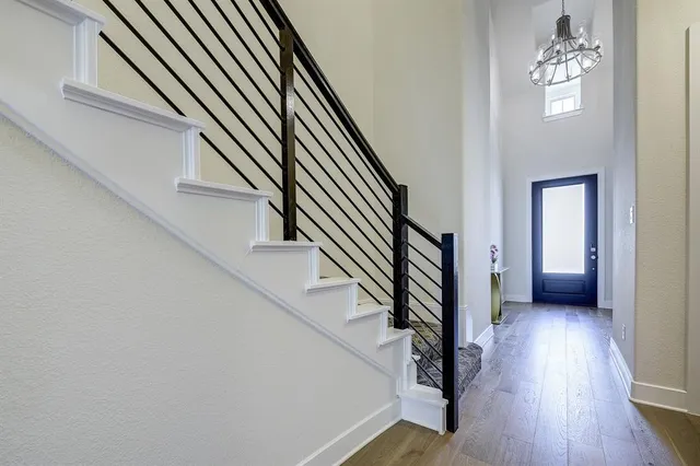 a view of entryway and hall with wooden floor
