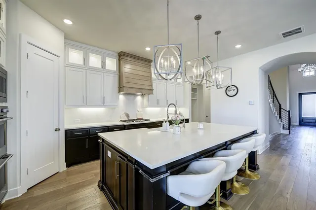 a kitchen with a table chairs and wooden floor