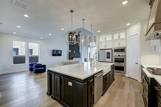 a large kitchen with stainless steel appliances granite countertop a stove and a center island