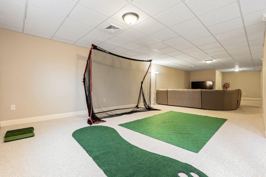 76 Deerfoot Road Southborough, MA 01772 - Photo 20 of 25 a room with a mirror and a wooden floor