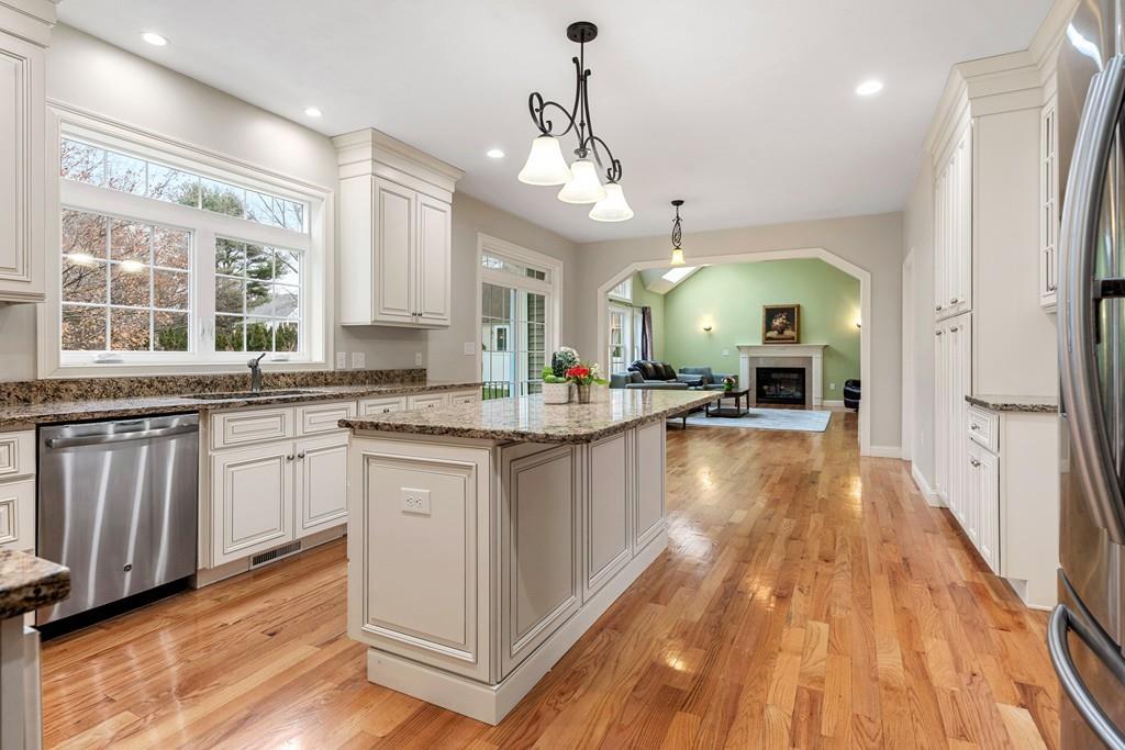 76 Deerfoot Road Southborough, MA 01772 - Photo 3 of 25 a large kitchen with cabinets a sink a window and stainless steel appliances