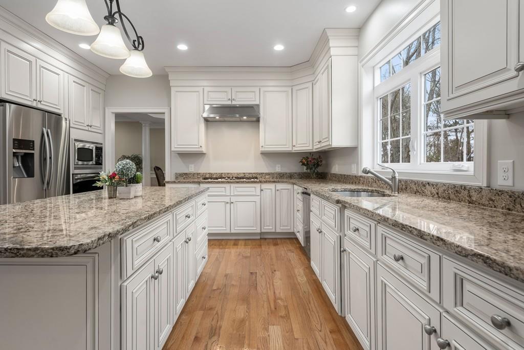 76 Deerfoot Road Southborough, MA 01772 - Photo 4 of 25 a large kitchen with kitchen island granite countertop lots of counter space and wooden floor