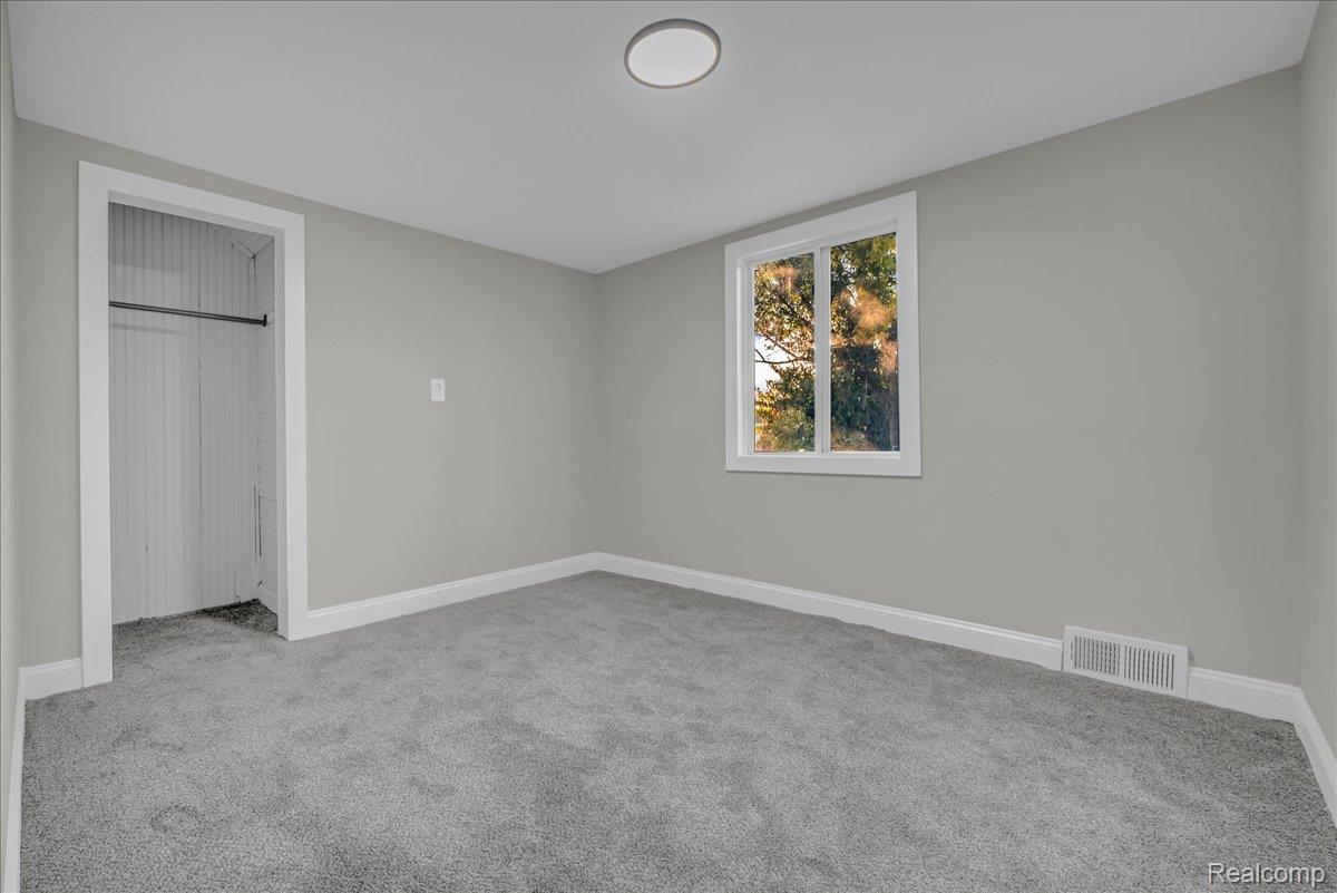 16717 Fielding Street Detroit, MI 48219 - Photo 35 of 46 Unfurnished bedroom with light colored carpet and a closet
