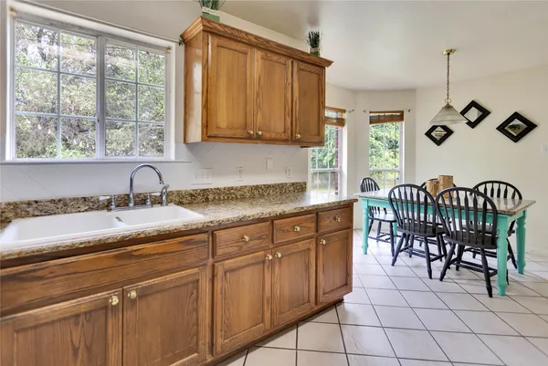 a kitchen with a sink and chairs
