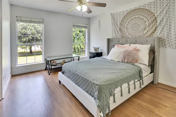 a large bedroom with a bed and a table in it