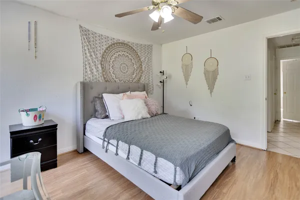 a bedroom with a bed and a chandelier