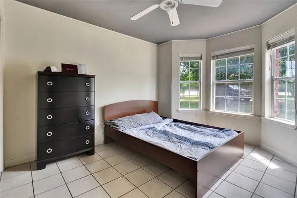a bedroom with a bed and a dresser
