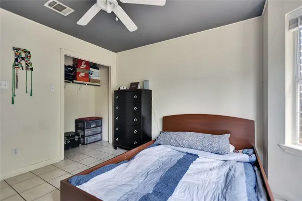 a bedroom with a bed and a dresser