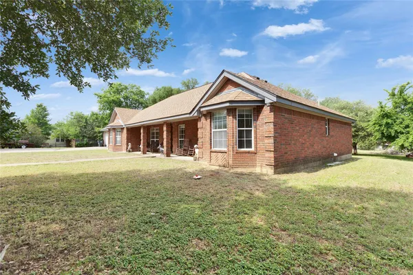 a front view of a house with yard and porch