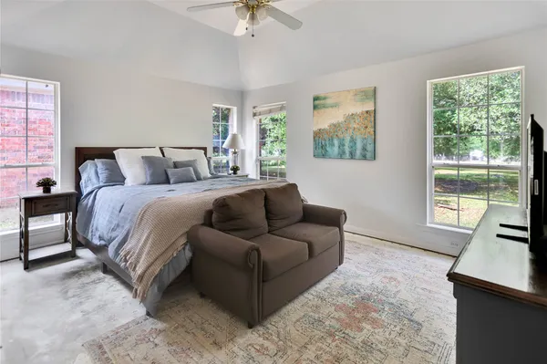 a spacious bedroom with a bed and a couch