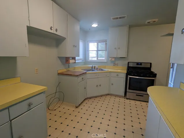 a kitchen with a sink a stove a refrigerator and a stove