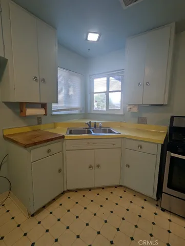 a kitchen with a sink a stove a microwave and cabinets