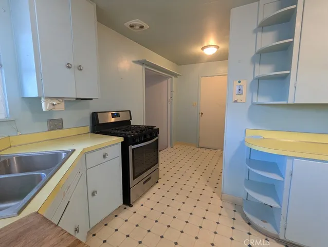 a kitchen with a sink a stove and refrigerator
