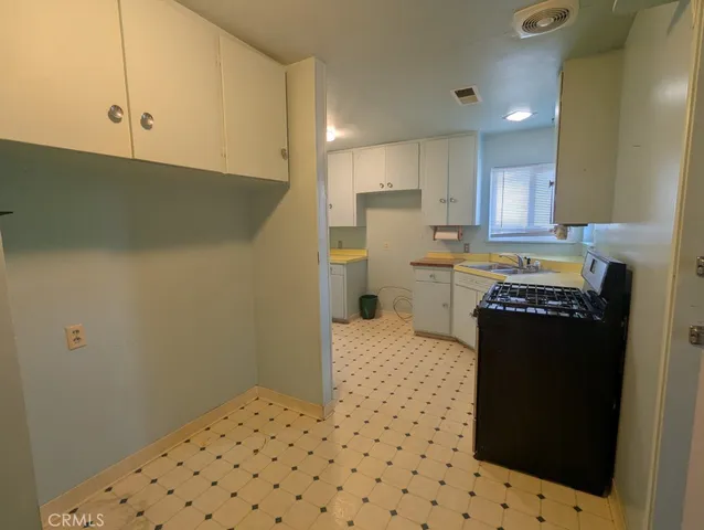 a kitchen with a refrigerator and cabinets