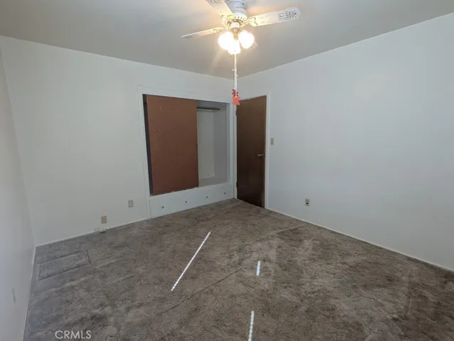 a view of a room with a chandelier fan