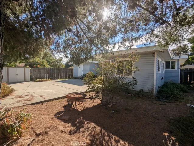 a view of a house with a small yard and wooden fence