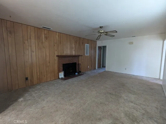an empty room with windows and a fireplace