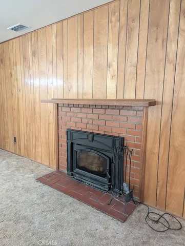 a living room with a fireplace and a wooden floor