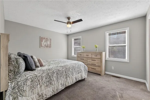 a bedroom with a large bed and a window