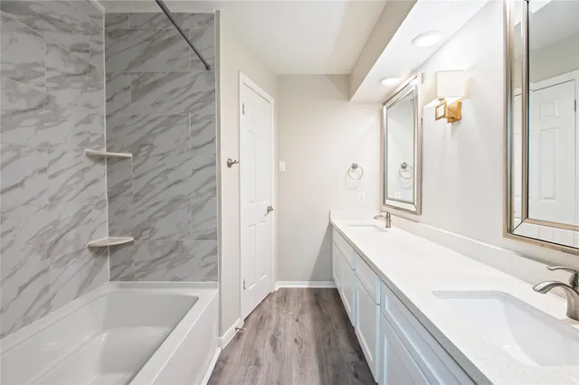 a bathroom with a bathtub and a sink
