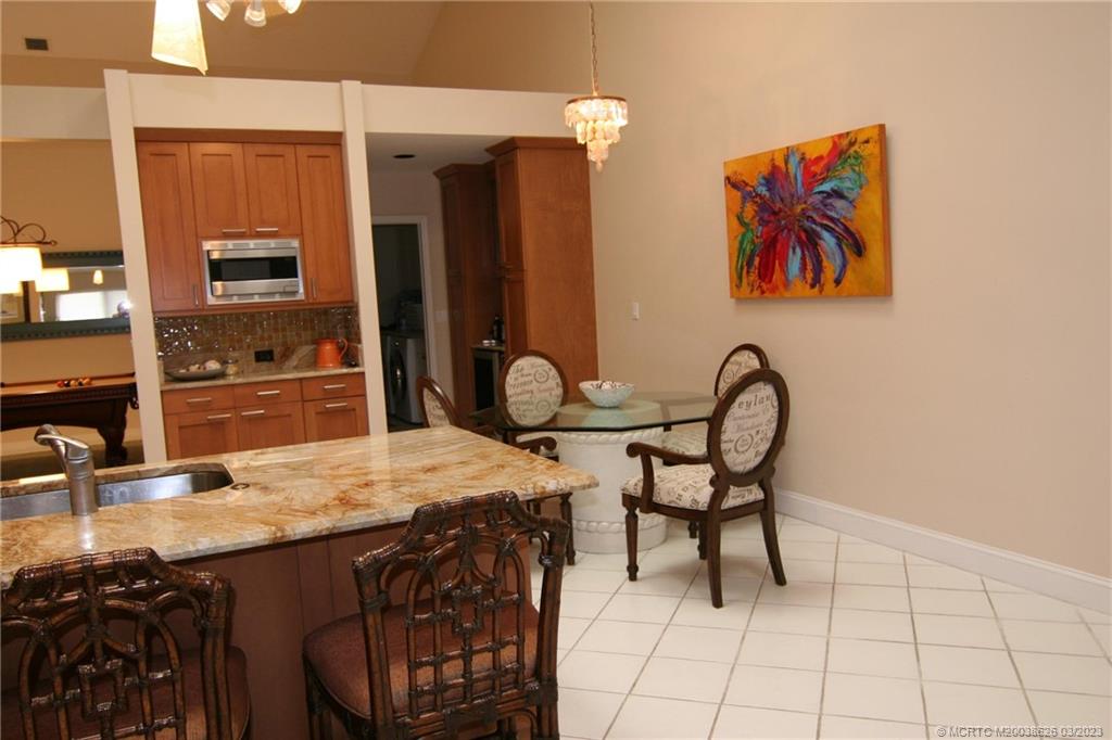 6945 Southeast Harbor Circle Stuart, FL 34996 - Photo 3 of 11 a view of a dining room with furniture
