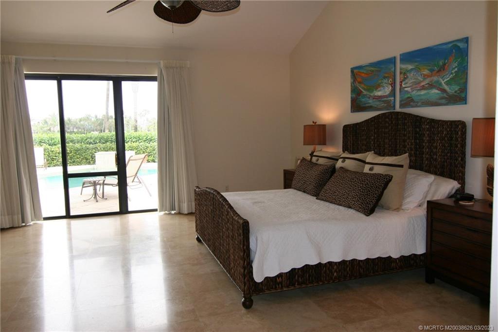 6945 Southeast Harbor Circle Stuart, FL 34996 - Photo 4 of 11 a bedroom with a bed and window
