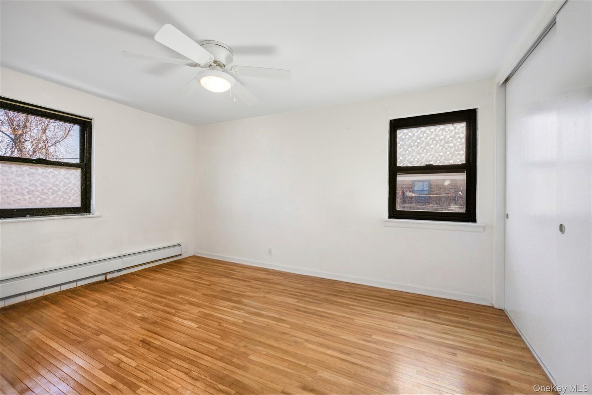 46 Terrace Circle, Unit 3F Great Neck, NY 11021 - Photo 11 of 17 a view of an empty room with wooden floor and a window