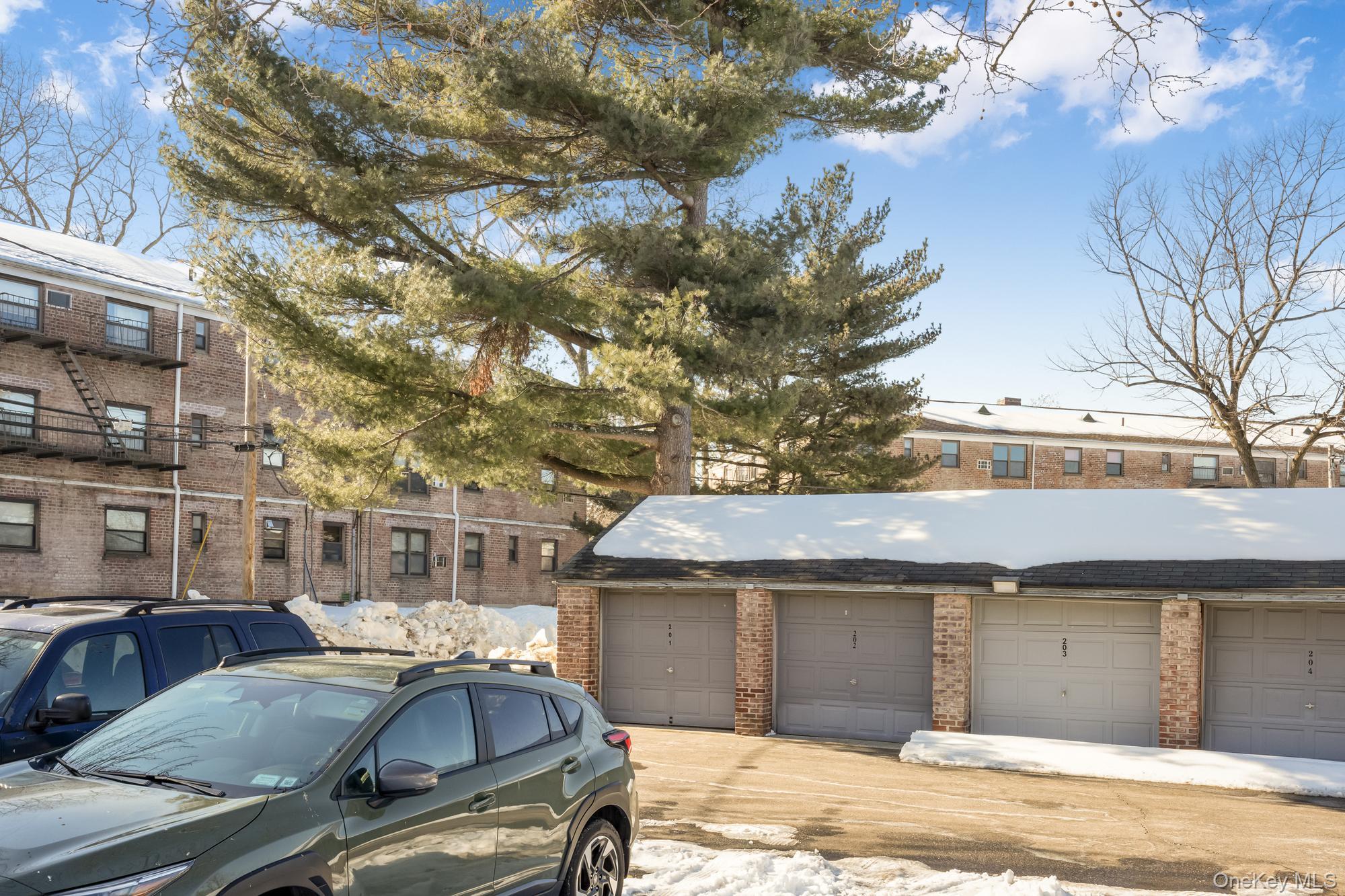 46 Terrace Circle, Unit 3F Great Neck, NY 11021 - Photo 16 of 17 a car parked in front of a building