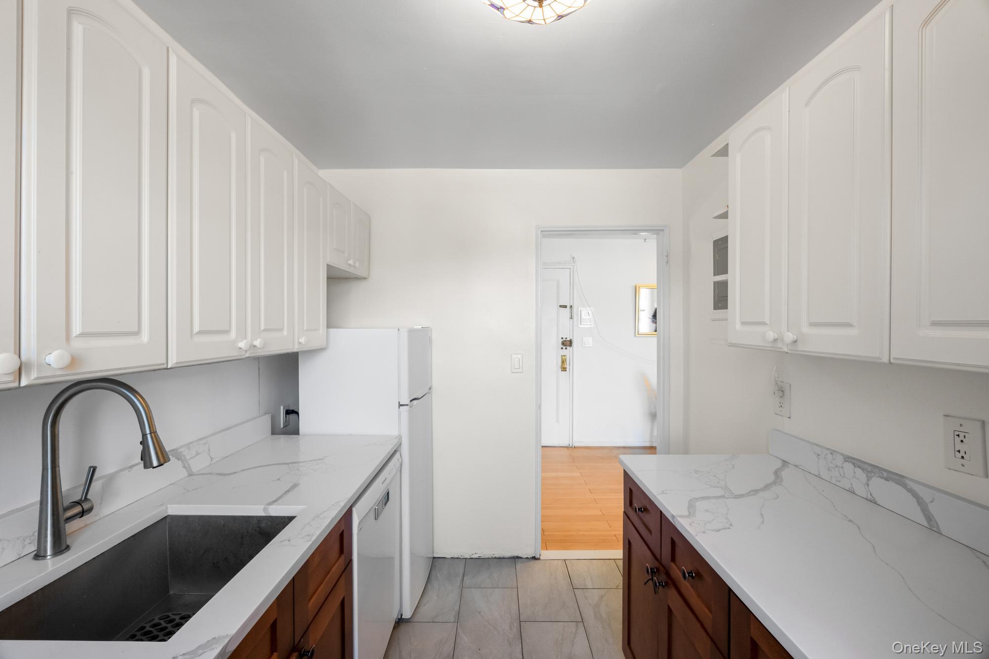 46 Terrace Circle, Unit 3F Great Neck, NY 11021 - Photo 8 of 17 a kitchen with stainless steel appliances granite countertop a sink stove and refrigerator