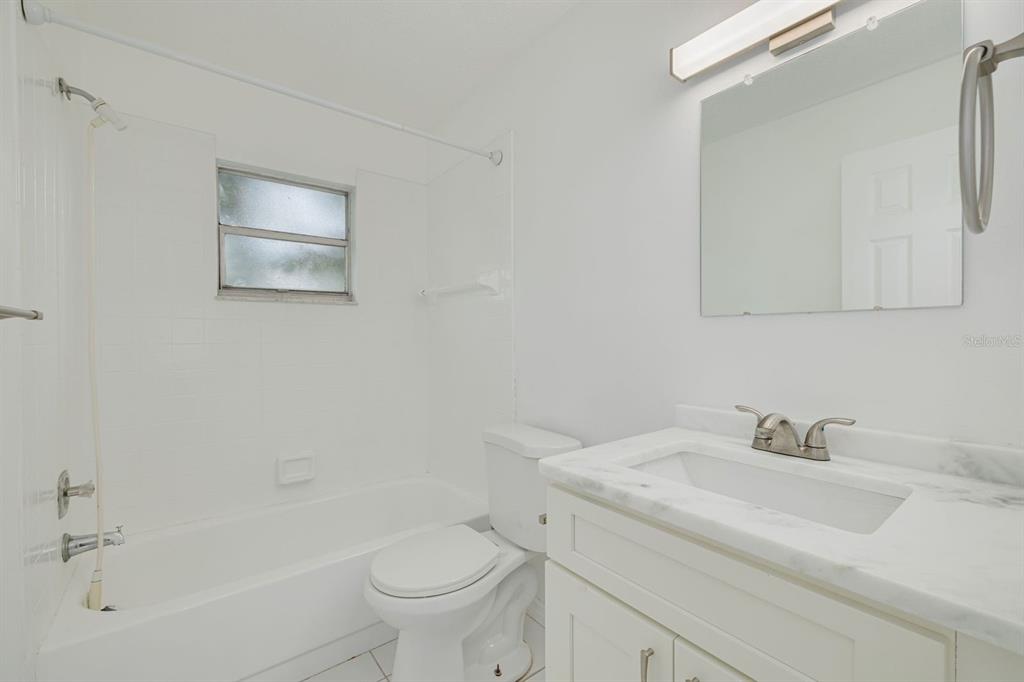 14519 Birch Street Hudson, FL 34667 - Photo 21 of 32 a bathroom with a sink toilet and vanity