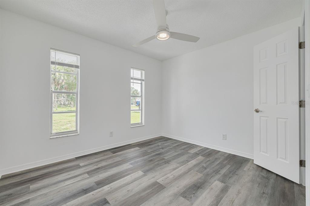 14519 Birch Street Hudson, FL 34667 - Photo 22 of 32 a view of empty room with wooden floor and fan