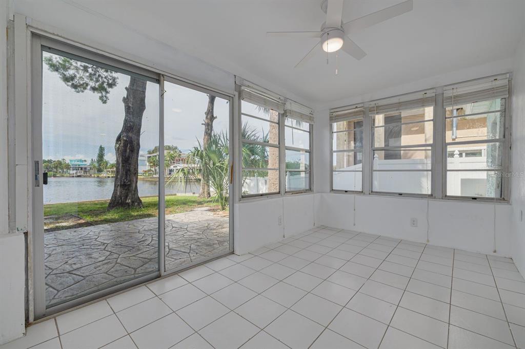 14519 Birch Street Hudson, FL 34667 - Photo 26 of 32 en empty room with sliding glass door and glass door