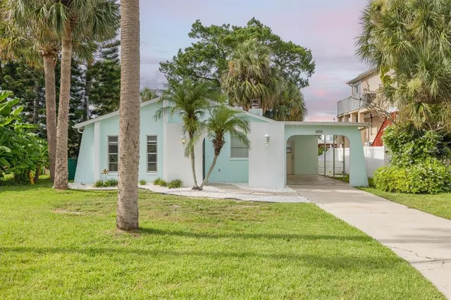a house that has a tree in front of it