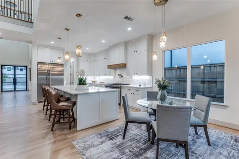 a large white kitchen with a large window